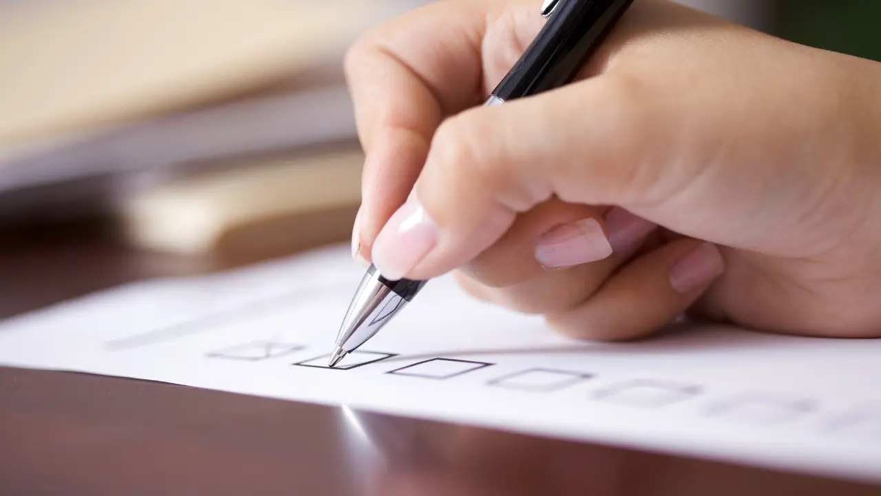 Pest Control Treatment Comprehensive Preparation Checklist woman at desk checking off her to do list for how to prepare for pest control treatments