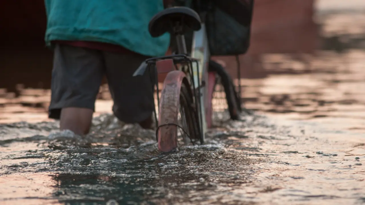 Addressing Mosquito Problems After Flooding in the Philippines a biker in a flooded road