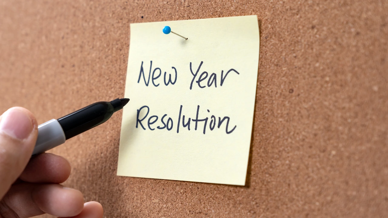 Kickstart the Year 7 New Years Resolutions for a Pest-Free Home A person writing his priorities for new year's resolution