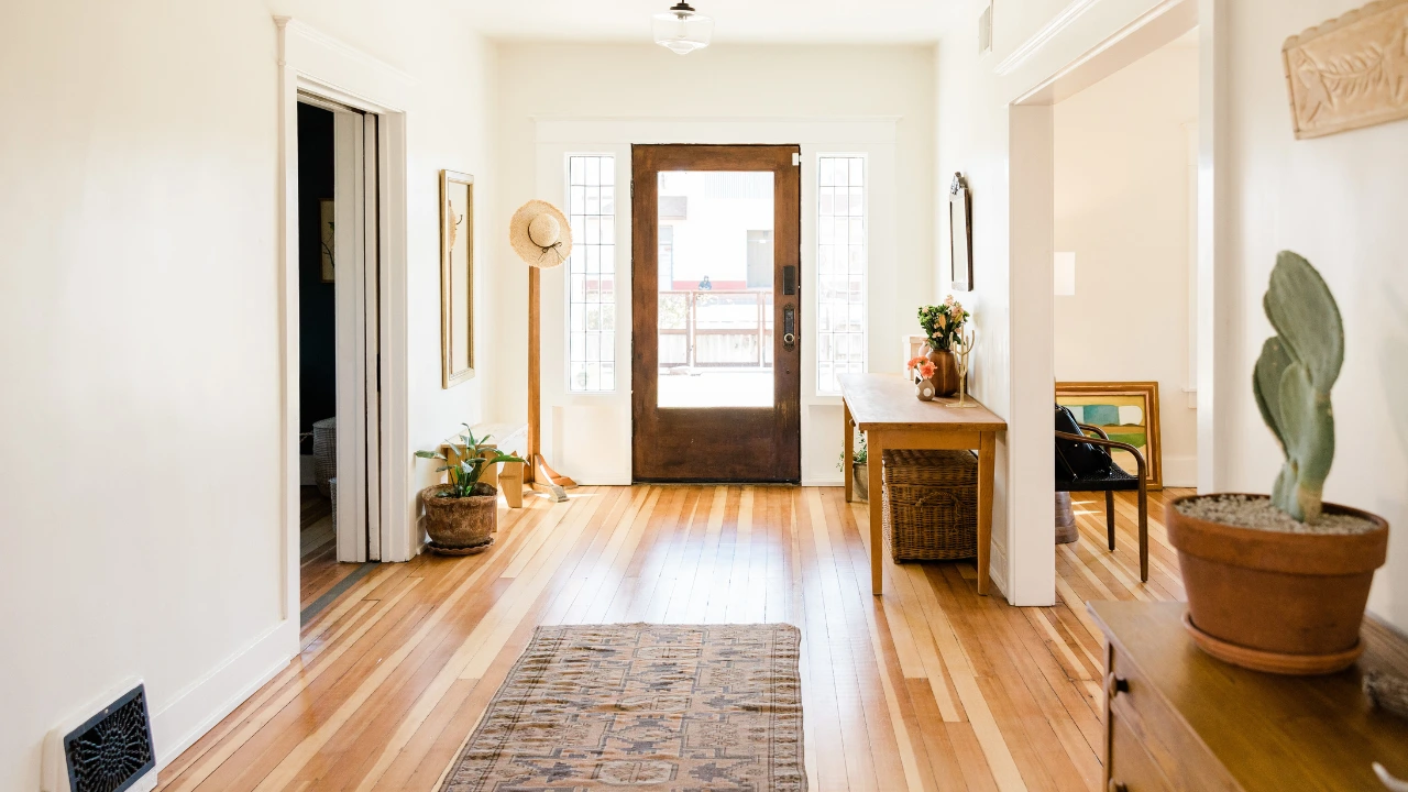 The Best Pest Control Resolutions for Homeowners This 2025 A tidy hallway showcasing a wooden floor and a door, illustrating pest control strategies for homeowners seeking cleanliness.