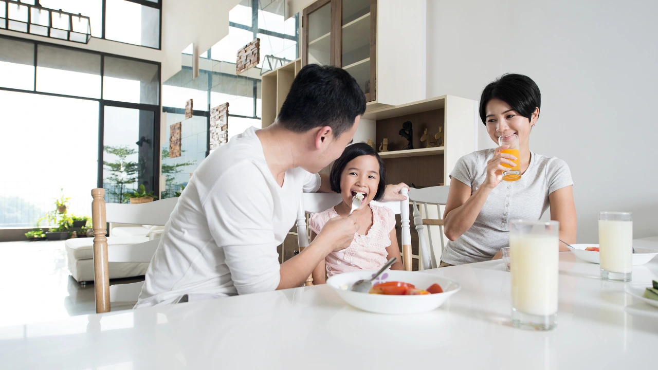 The Best Valentine’s Gift A Pest-Free and Healthy Home A family enjoys breakfast together in a modern home, symbolizing love and health in a pest-free environment.
