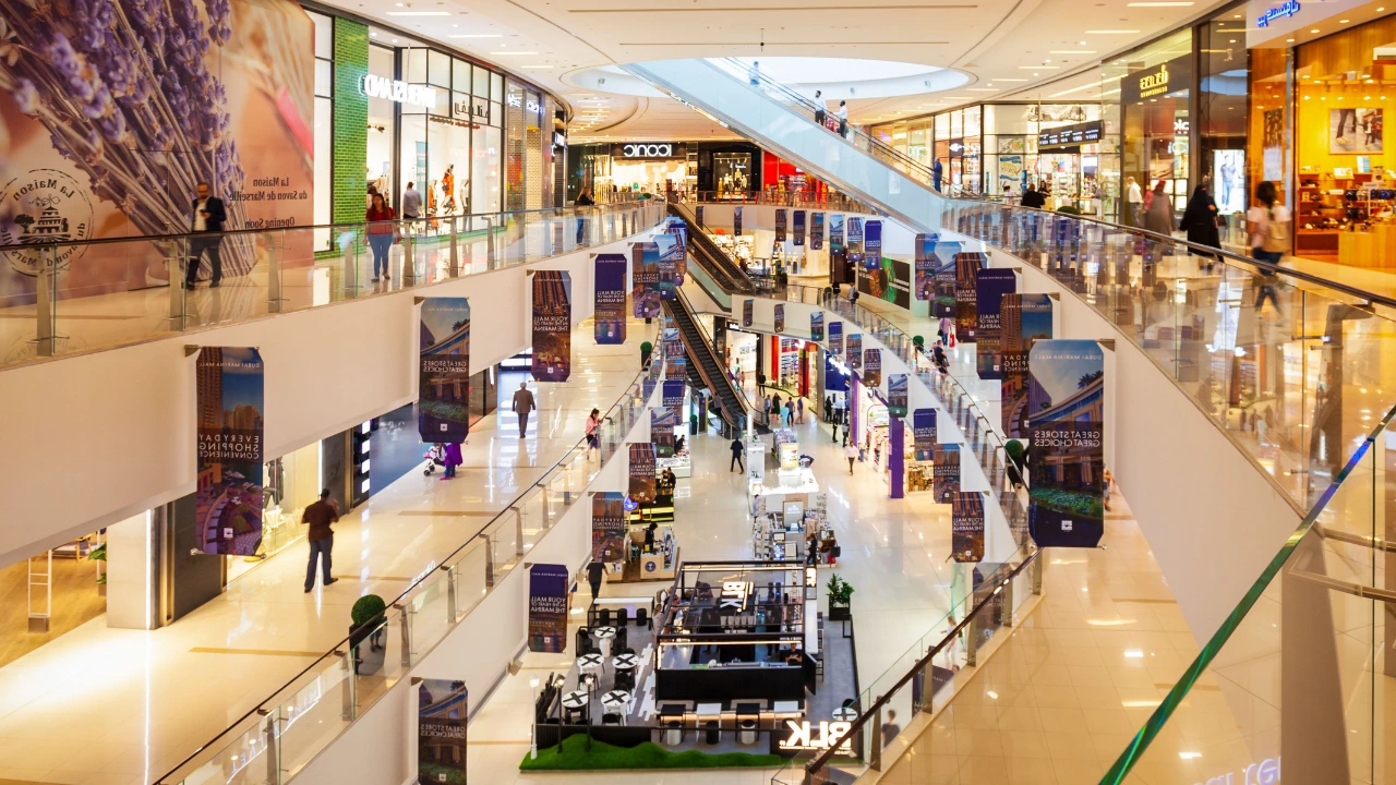 Mall Maintenance How to Keep Pests Away from Your Business Spaces Crowded mall interior with numerous shoppers and a maintenance team working on upkeep in the background.