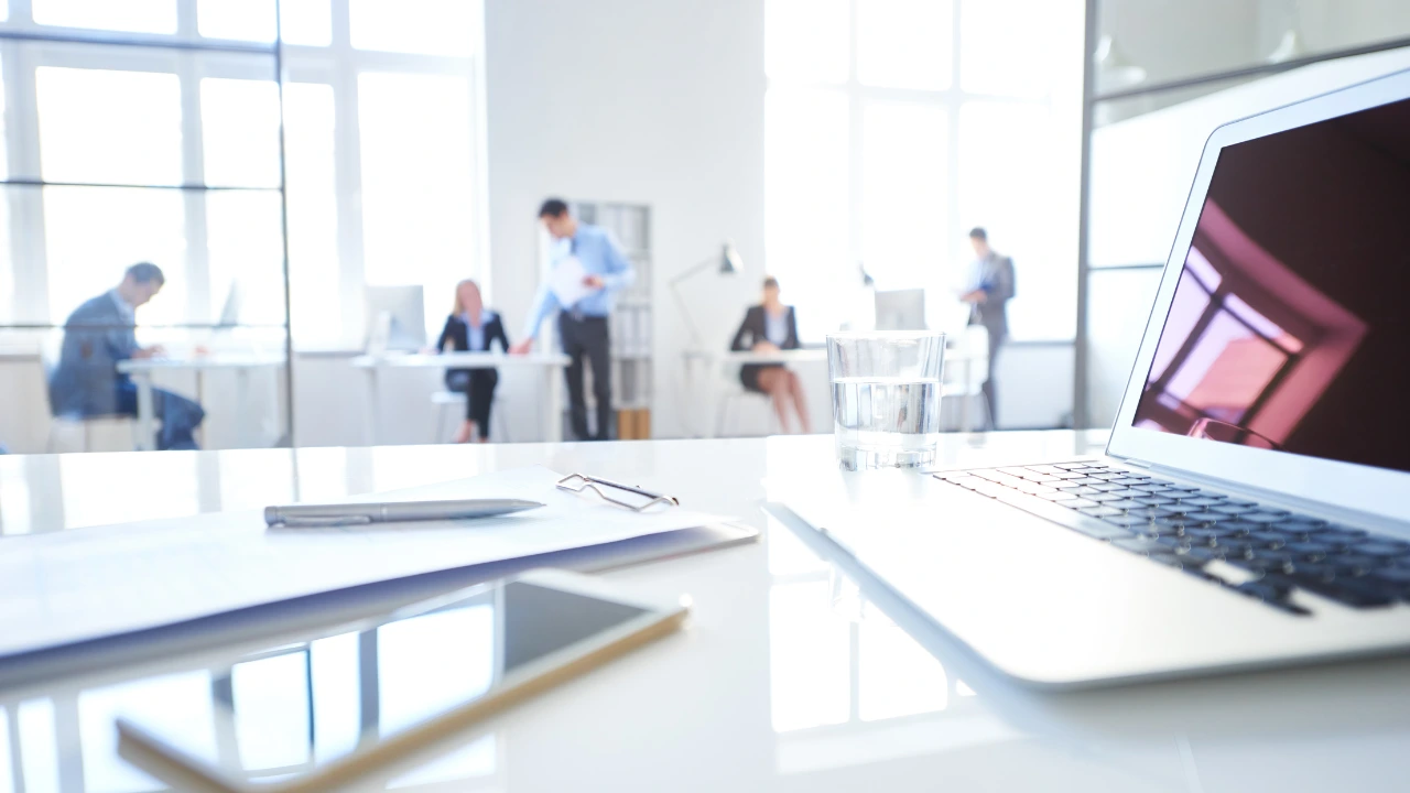 Office Pest Control Keep Your Workplace Productive and Pest-Free A laptop on a desk accompanied by a pen and notepad, symbolizing a productive and pest-free office environment.