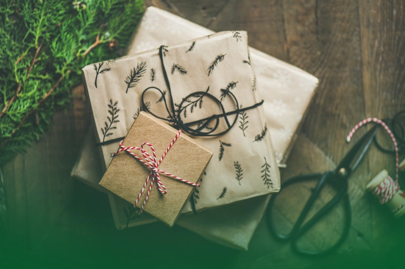 Christmas Ber-months Celebration a bag with presents and a branch