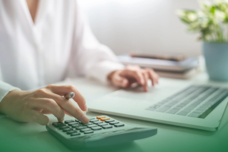 Cost Savings woman entreprenuer using calculator