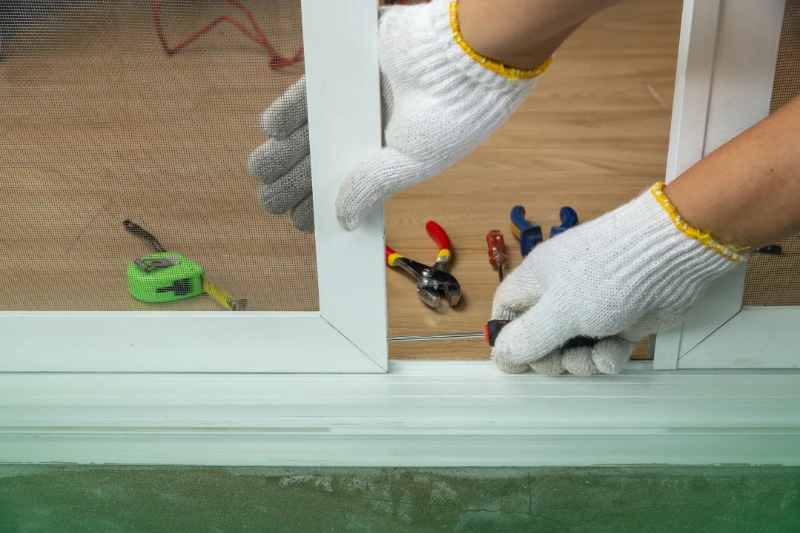 Invest in Pest-Resistant Materials and Products a worker fixing the insect screen sliding door
