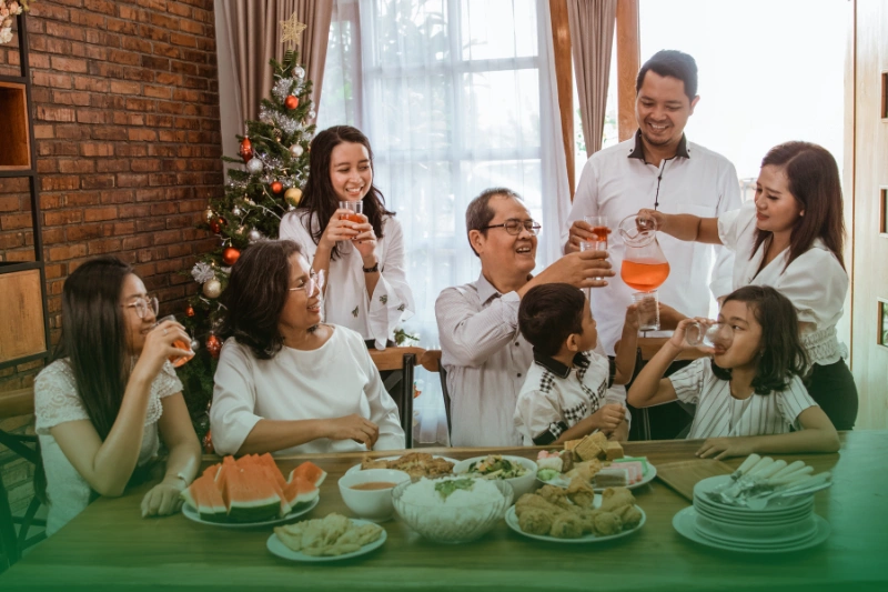Noche Buena_Grand Feasting a group of people drinking and eating food together during Christmas