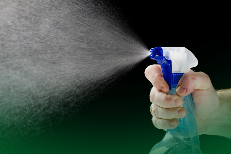 Soap and Water Spray a man spraying a liquid sprayer on black background